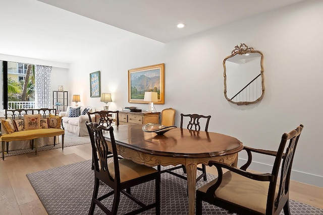 dining space with light hardwood / wood-style flooring