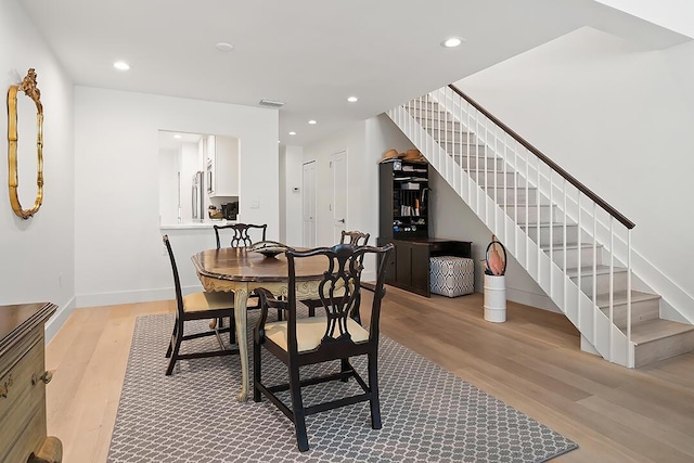 dining space featuring light wood-type flooring