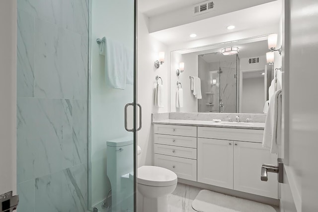 bathroom featuring vanity, toilet, and a shower with shower door