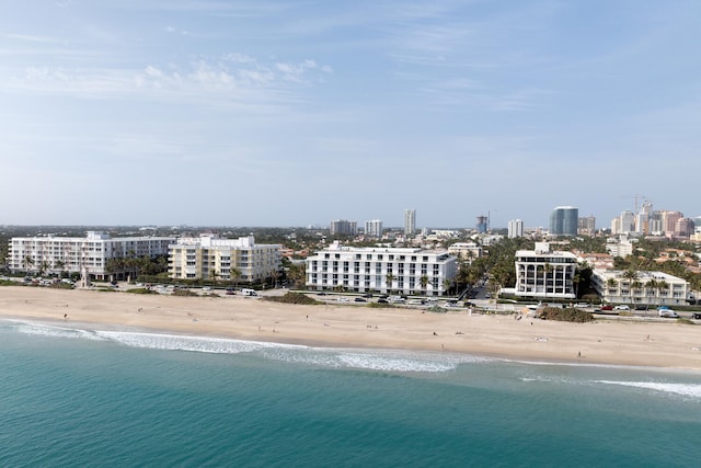 birds eye view of property featuring a view of the beach and a water view