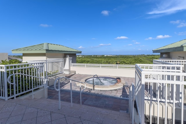 view of patio / terrace featuring an in ground hot tub