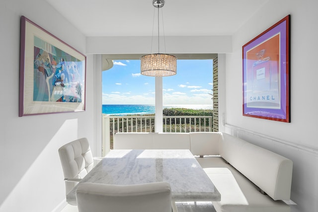 dining area featuring breakfast area and a water view