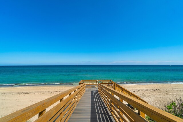 surrounding community featuring a water view and a view of the beach