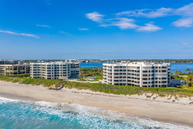 drone / aerial view with a beach view and a water view