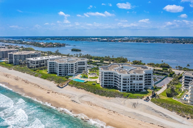 bird's eye view with a water view and a beach view