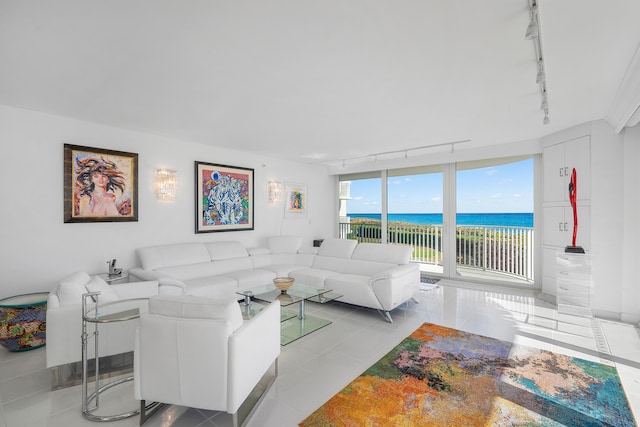 living room with light tile patterned floors, track lighting, and a water view