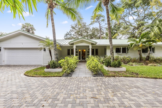 single story home featuring french doors and a garage