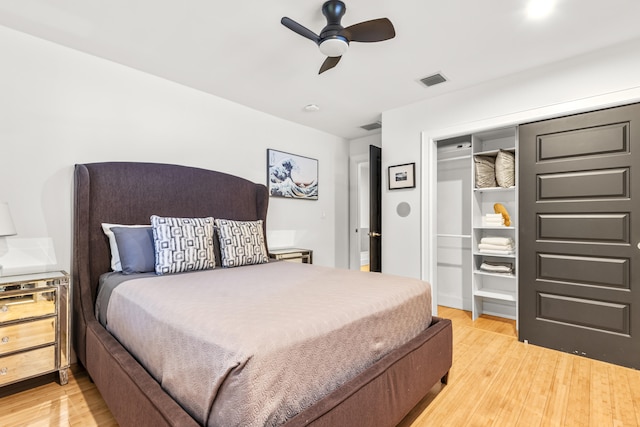 bedroom featuring ceiling fan, a closet, and light hardwood / wood-style floors