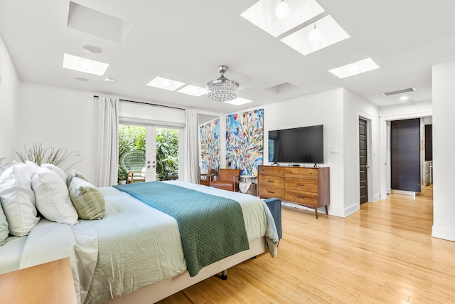 bedroom with french doors, light wood-type flooring, a closet, and ceiling fan