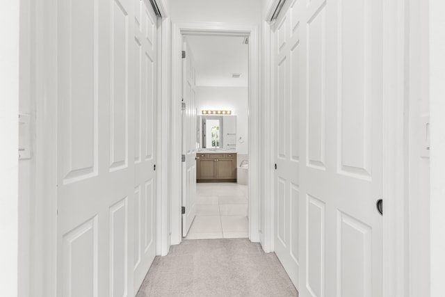 hall with light tile patterned floors