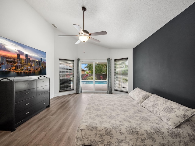 unfurnished bedroom with hardwood / wood-style floors, access to exterior, ceiling fan, and a textured ceiling