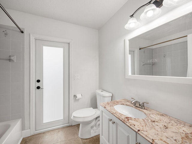 full bathroom featuring toilet, vanity, tile patterned floors, and tiled shower / bath combo