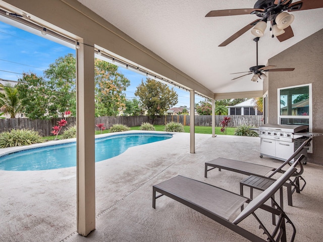 view of pool featuring ceiling fan, a patio, and grilling area