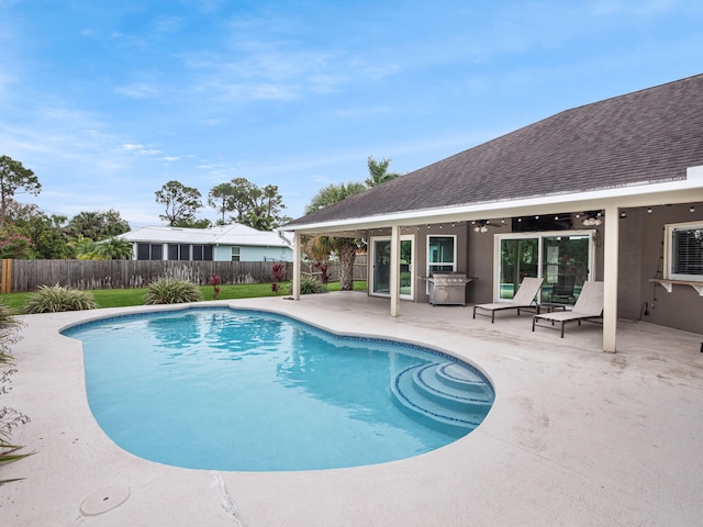 view of pool with ceiling fan and a patio area