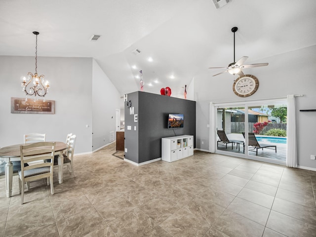 interior space featuring ceiling fan with notable chandelier, high vaulted ceiling, and light tile patterned floors