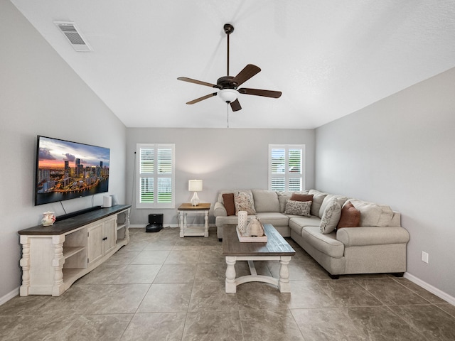 living room with ceiling fan, a wealth of natural light, and lofted ceiling