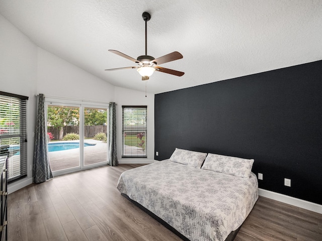 bedroom with a textured ceiling, vaulted ceiling, ceiling fan, access to exterior, and wood-type flooring