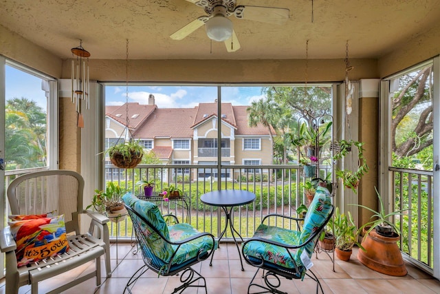 sunroom / solarium featuring ceiling fan