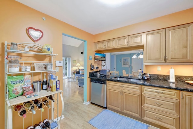 kitchen featuring dishwasher, sink, dark stone countertops, light brown cabinetry, and light hardwood / wood-style floors