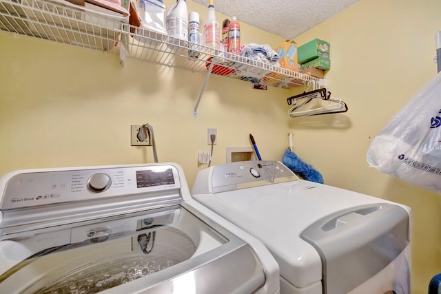 washroom featuring independent washer and dryer and a textured ceiling