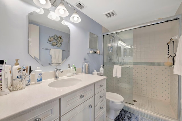 bathroom with vanity, toilet, and walk in shower