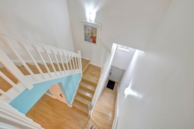 stairs with wood-type flooring