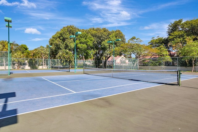 view of tennis court with basketball hoop