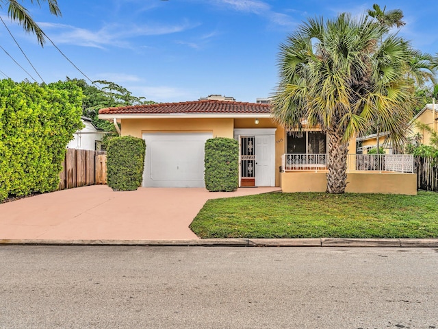 mediterranean / spanish-style house with a garage and a front yard