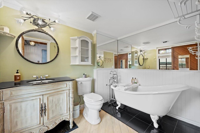 bathroom featuring vanity, wood finished floors, visible vents, a freestanding bath, and toilet