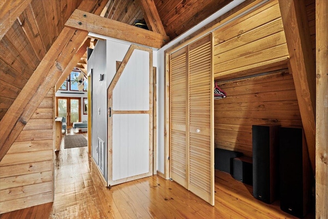 corridor with visible vents, wood ceiling, hardwood / wood-style floors, and vaulted ceiling