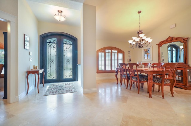 foyer entrance featuring french doors and a notable chandelier