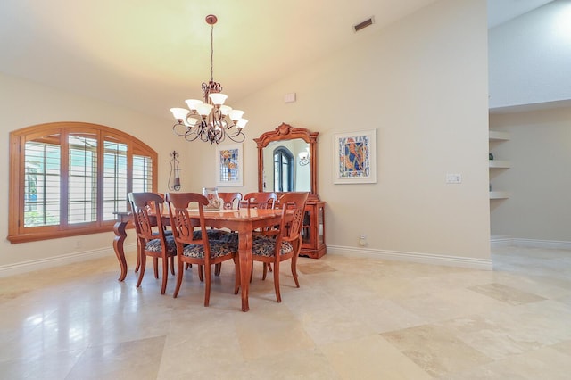 dining room featuring built in features, lofted ceiling, and a chandelier