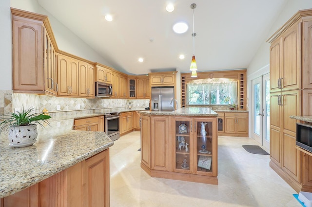 kitchen featuring vaulted ceiling, stainless steel appliances, french doors, and decorative light fixtures