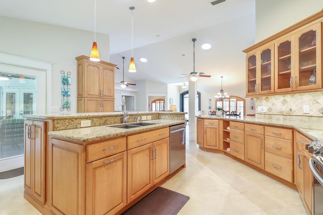 kitchen featuring decorative light fixtures, stainless steel appliances, tasteful backsplash, sink, and a center island with sink