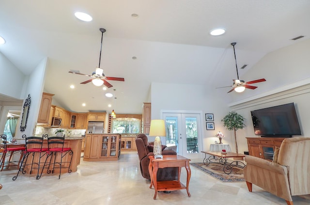 living room featuring high vaulted ceiling and french doors