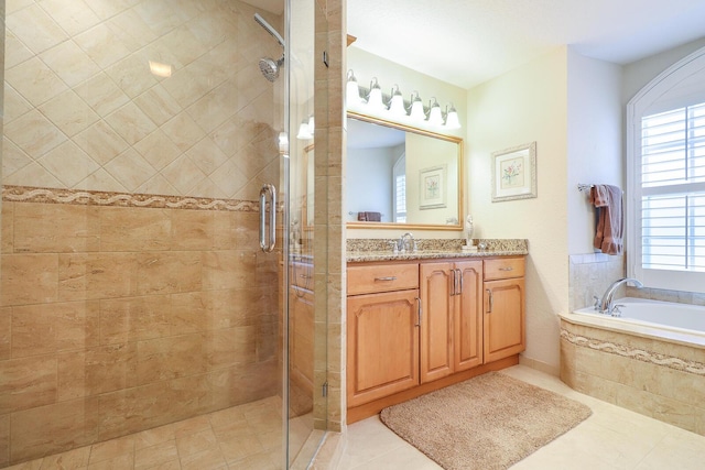 bathroom featuring tile patterned flooring, vanity, and plus walk in shower