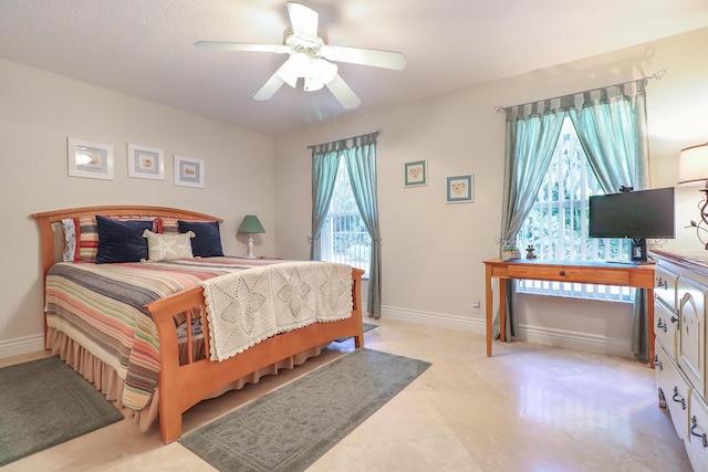 bedroom with ceiling fan and multiple windows