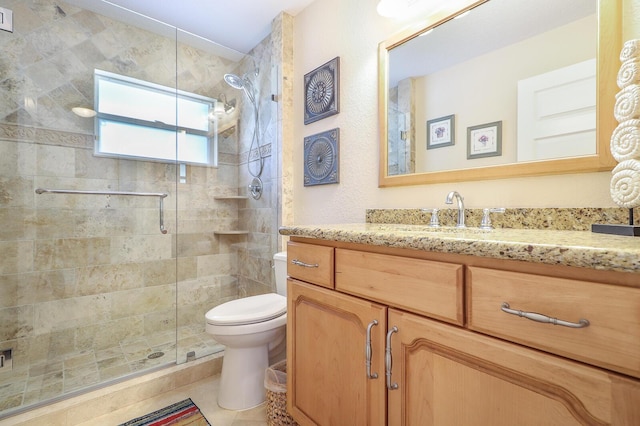 bathroom with toilet, tile patterned flooring, a shower with door, and vanity