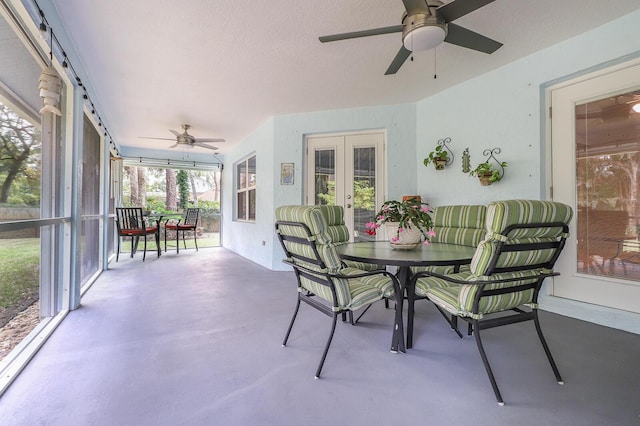 sunroom featuring ceiling fan and french doors