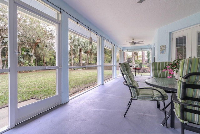 sunroom featuring ceiling fan