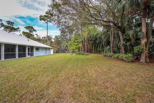 view of yard with a sunroom