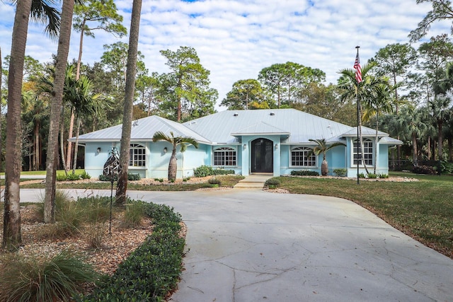 ranch-style home with a front lawn