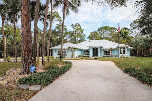 ranch-style home featuring a front yard