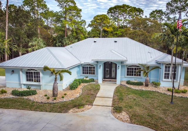 view of front of property with a front yard and french doors