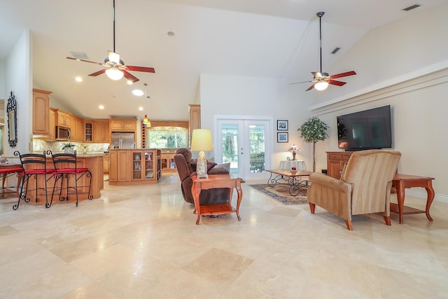 living room featuring ceiling fan, french doors, and vaulted ceiling