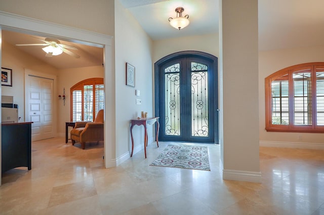 entryway with ceiling fan, french doors, and vaulted ceiling