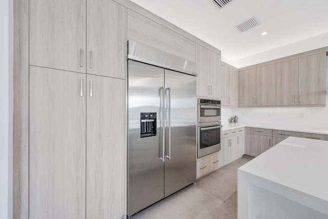 kitchen featuring appliances with stainless steel finishes and light brown cabinets