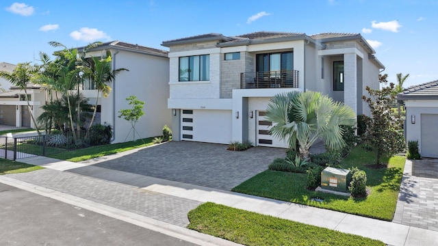 view of front of home with a garage and a balcony