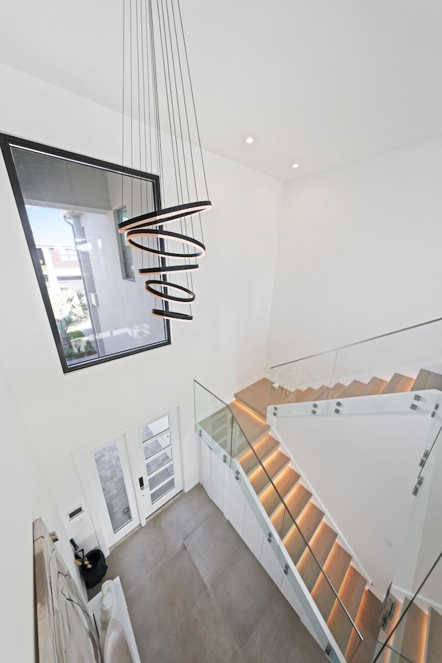 stairs featuring concrete flooring