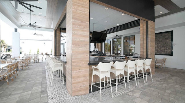 kitchen with a kitchen bar and a towering ceiling